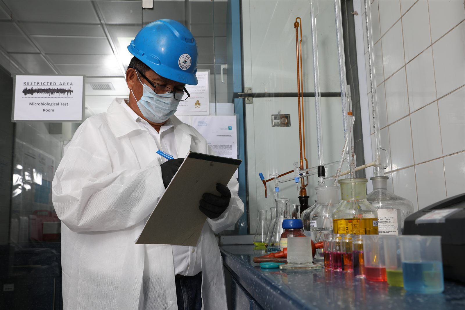 SAWACO laboratory technician recording results in the microbiological test room